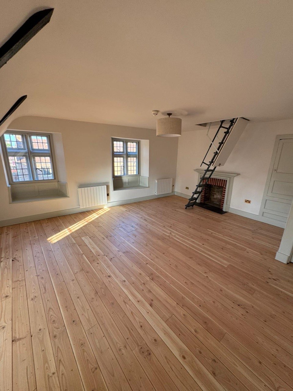 Finished room with restored timber flooring and freshly painted walls